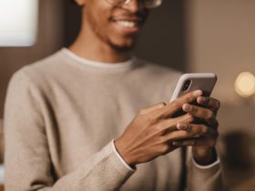 smiley man using modern smartphone